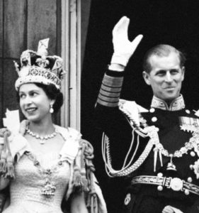 The Queen and the Duke of Edinburgh wave from the balcony of Buckingham Palace at her Coronation in 1953